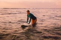 Beautiful surfgirl on a surfboard in ocean.