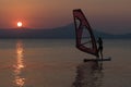 Beautiful surfing woman silhouette against the sunset as background. Royalty Free Stock Photo