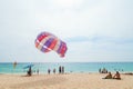 Beautiful Surin beach in Choeng Thale city, Phuket, Thailand with colorful parachute white sand, turquoise water and palm trees