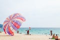 Beautiful Surin beach in Choeng Thale city, Phuket, Thailand with colorful parachute white sand, turquoise water and palm trees