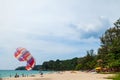 Beautiful Surin beach in Choeng Thale city, Phuket, Thailand with colorful parachute white sand, turquoise water and palm trees