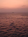 Violet Sunrise on The Sea with A Ship on Horizon