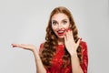 Beautiful surprised shocked woman model with red lips makeup and manicured nails on white background