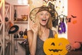 Beautiful surprised woman - Vampire Halloween portrait. Woman posing with Pumpkin. Halloween Witch. Royalty Free Stock Photo