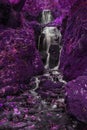 Beautiful surreal alternative color tall waterfall flowing over