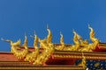 Beautiful swan and naga sculptures on the church roof under the blue sky background at Wat Rong Suea Ten Temple, also known as the Royalty Free Stock Photo