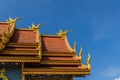 Beautiful swan and naga sculptures on the church roof under the blue sky background at Wat Rong Suea Ten Temple, also known as the Royalty Free Stock Photo