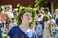 Beautiful swedish people and kids are enjoying mid summer day wearing crown made of leaves in sunny day