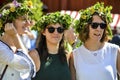 Beautiful swedish sweet happy womans are enjoying traditional decoration of mid summer day wearing colourful leave crown in sunny