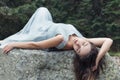 Beautiful sweet girl bride in her wedding dress light air in the mountains near the lake, a beautiful landscape of mountains