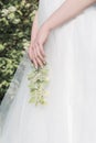 Beautiful sweet girl bride in a tender air wedding dress in a blooming spring garden in the rays of sunlight at sunset. Fine art Royalty Free Stock Photo