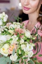 Beautiful sweet girl bridesmaid preparing for the wedding of a friend in the pink evening dress with evening hairstyle and bright Royalty Free Stock Photo