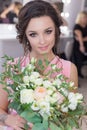 Beautiful sweet girl bridesmaid preparing for the wedding of a friend in the pink evening dress with evening hairstyle and bright Royalty Free Stock Photo