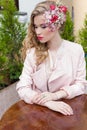 Beautiful sweet girl with hair and make-up color bright sitting at a table at an outdoor cafe and waiting for your order