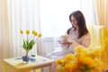 Beautiful sweet girl in nightgown in early morning with bouquet of delicate yellow tulips. Gift on International Royalty Free Stock Photo