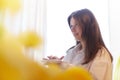 Beautiful sweet girl in nightgown in early morning with bouquet of delicate yellow tulips. Gift on International Royalty Free Stock Photo