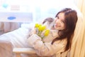 Beautiful sweet girl in nightgown in early morning with bouquet of delicate yellow tulips. Gift on International Royalty Free Stock Photo