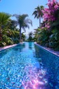 Aqua oasis with palm trees, pink flowers, and azure sky around the swimming pool