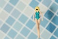 Beautiful swimsuit Women plastic toy top view on blue background