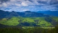 Beautiful swiss alps. Amazing mountain view with high peaks, green hills and clouds low in the valley Royalty Free Stock Photo