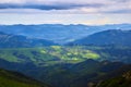 Beautiful swiss alps. Amazing mountain view with high peaks, green hills and clouds low in the valley Royalty Free Stock Photo