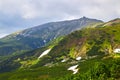 Beautiful swiss alps. Amazing mountain view with high peaks, green hills and clouds low in the valley Royalty Free Stock Photo