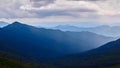 Beautiful swiss alps. Amazing mountain view with high peaks, green hills and clouds low in the valley Royalty Free Stock Photo