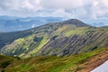 Beautiful swiss alps. Amazing mountain view with high peaks, green hills and clouds low in the valley Royalty Free Stock Photo