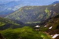 Beautiful swiss alps. Amazing mountain view with high peaks, green hills and clouds low in the valley Royalty Free Stock Photo