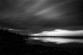 Beautiful and symmetric sunset over Trasimeno lake shoreUmbria, Italy, with moving clouds