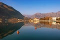 Beautiful symmetrical landscape where mountains are reflected in water. Montenegro, view of Bay of Kotor near Kotor city