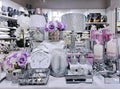 Beautiful table decoration - lamps, candles, watches in silver color and festive tableware.