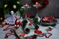 Beautiful table setting. Candles on glasses against the background of Christmas decor