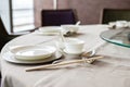 Beautiful table setting with china porcelain and chopsticks eating utensils