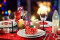 Beautiful table setting for Christmas party or New Year celebration at home. Cozy room with a fireplace and Christmas tree in a ba Royalty Free Stock Photo