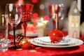 Beautiful table setting for Christmas party or New Year celebration at home. Cozy room with a fireplace and Christmas tree in a ba Royalty Free Stock Photo