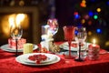 Beautiful table setting for Christmas party or New Year celebration at home. Cozy room with a fireplace and Christmas tree in a ba Royalty Free Stock Photo