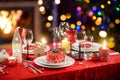 Beautiful table setting for Christmas party or New Year celebration at home. Cozy room with a fireplace and Christmas tree in a Royalty Free Stock Photo