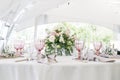 Beautiful table setting with crockery and flowers for a party, wedding reception or other festive event. Glassware and Royalty Free Stock Photo