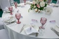 Beautiful table setting with crockery and flowers for a party, wedding reception or other festive event. Glassware and cutlery for Royalty Free Stock Photo