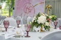 Beautiful table setting with crockery and flowers for a party, wedding reception or other festive event. Glassware and cutlery for Royalty Free Stock Photo