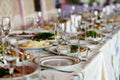 Beautiful table setting with crockery and flowers for a party, wedding reception or other festive event. Glassware and cutlery for Royalty Free Stock Photo