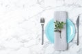 Beautiful table setting with napkin on marble background, top view. Royalty Free Stock Photo