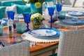 Beautiful table setting with a sea theme with blue wine glass cups and plates Royalty Free Stock Photo