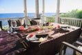 Beautiful table setting on terrace near ocean