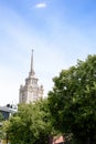 A beautiful tall building, a Stalin skyscraper on the background of a part of the building of the ukraine hotel against the blue s Royalty Free Stock Photo