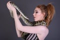 Beautiful, Tall, Slim, Busty Redhead Model in a sexy, black, mesh Dress, posing with a Snake