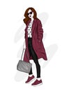 Beautiful, tall and slender girl in a stylish coat, trousers, and glasses. Stylish woman in high-heeled shoes. Fashion & Style.