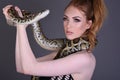 Beautiful, Tall, Slim, Busty Redhead Model in a sexy, black, mesh Dress, posing with a Snake Royalty Free Stock Photo