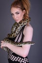 Beautiful, Tall, Slim, Busty Redhead Model in a sexy, black, mesh Dress, posing with a Snake Royalty Free Stock Photo